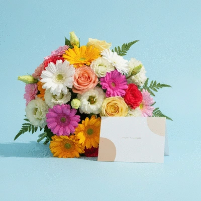 Beautifully arranged bouquet of fresh flowers with a personalized greeting card on a clean background
